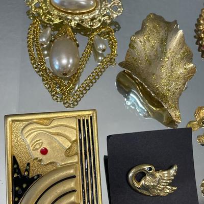 Gold tone brooches