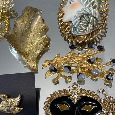 Gold tone brooches