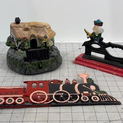 Cast Iron:   Bank, Nut Cracker and a Wall Plaque 