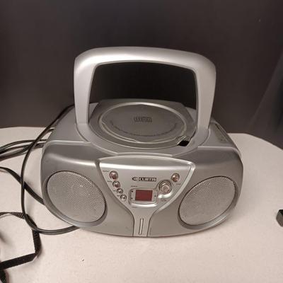 CANON SURE SHOT 35MM & POLAROID CAMERA PLUS A CURTIS RADIO/CD PLAYER (NO ANTENNA)