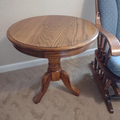 GLIDER, FAUX FLORAL SWAG AND A SIDE TABLE