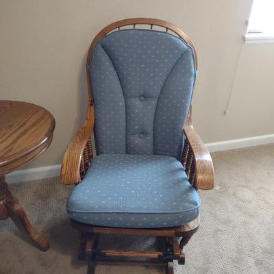 GLIDER, FAUX FLORAL SWAG AND A SIDE TABLE