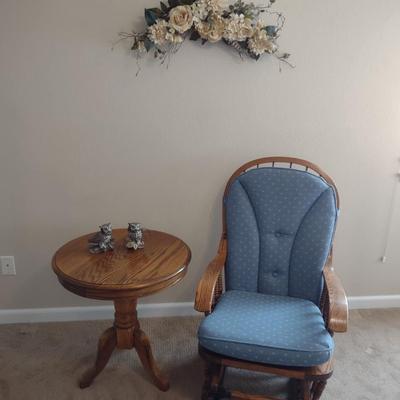 GLIDER, FAUX FLORAL SWAG AND A SIDE TABLE