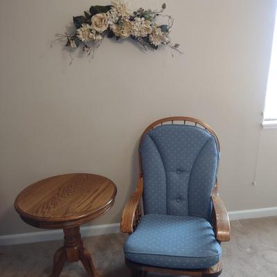 GLIDER, FAUX FLORAL SWAG AND A SIDE TABLE