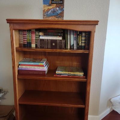 BOOKCASE WITH A VARIETY OF BOOKS