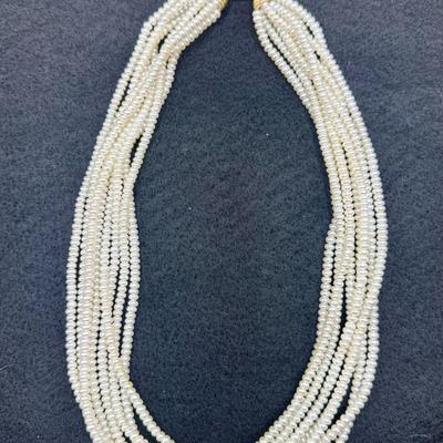 Sale Photo Thumbnail #167: 8-strand freshwater seed pearl necklace with a 14K gold clasp. Clasp is marked "ADPG" and "14K". Overall necklace weight is 55g.  Excellent condition.