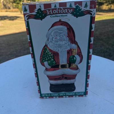Sale Photo Thumbnail #310: Metallic Ceramic Santa figurine  see photos for size.  it might be a little bigger than you expect,. not an ornament size more like the height of an insulated cup.