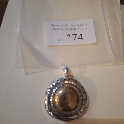 Sale Photo Thumbnail #953: round gold and silver tone pendant statement piece