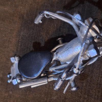 Sale Photo Thumbnail #1091: Miniature motorcycle sculpture made from various recycled items