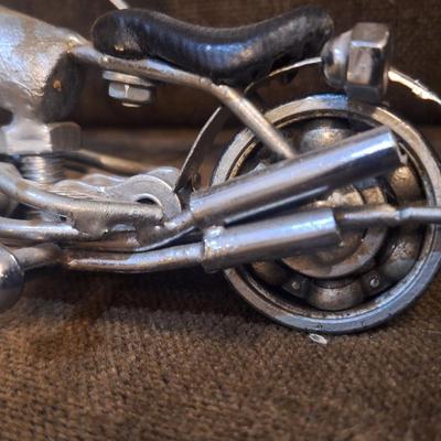 Sale Photo Thumbnail #1088: Miniature motorcycle sculpture made from various recycled items