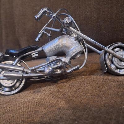 Sale Photo Thumbnail #1090: Miniature motorcycle sculpture made from various recycled items