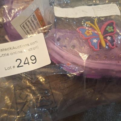 Sale Photo Thumbnail #1286: these show a 20 on the bottom so that would be the EU size.- we recommend you research the size cross reference yourself but it looks like they fit probably a 12 month old   they are new, pink with butterfly.