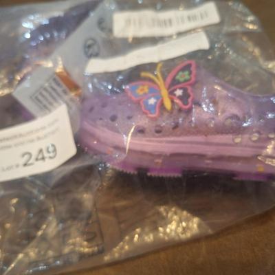 Sale Photo Thumbnail #1278: these show a 20 on the bottom so that would be the EU size.- we recommend you research the size cross reference yourself but it looks like they fit probably a 12 month old   they are new, pink with butterfly.