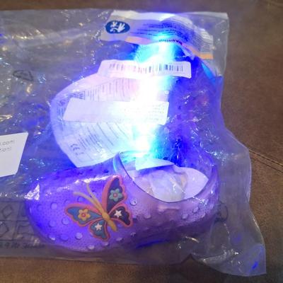 Sale Photo Thumbnail #1285: these show a 20 on the bottom so that would be the EU size.- we recommend you research the size cross reference yourself but it looks like they fit probably a 12 month old   they are new, pink with butterfly.