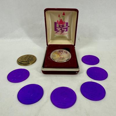 Sale Photo Thumbnail #177: This is a Disneyland 35th Anniversary Commemorative Limited Edition 1 oz Silver Coin set. The set includes a silver coin, a certificate of authenticity, and several purple plastic "doubloons".