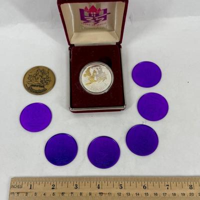 Sale Photo Thumbnail #178: This is a Disneyland 35th Anniversary Commemorative Limited Edition 1 oz Silver Coin set. The set includes a silver coin, a certificate of authenticity, and several purple plastic "doubloons".