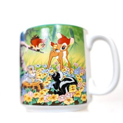 Sale Photo Thumbnail #229: Disney store Bambi collectible mug. This mug features scenes from the movie Bambi with characters including Bambi, Thumper the rabbit, Flower the skunk , and the Friend Owl. Its a ceramic mug with a teal-colored interior.