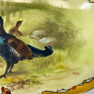 Sale Photo Thumbnail #232: Marked with the Limoges, France decorating firm '"MR France" mark, for Martial Redon, circa 1920's. Signed by the artist. 
This lovely plate features a scalloped rim with a heavy gold border. The center scene is of a male black grouse game bird watching o