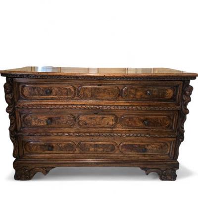 Beautiful ornately carved fruitwood chest of drawers with carved figural wreathing at the sides and carved feet. 18th C. Figural carvings...