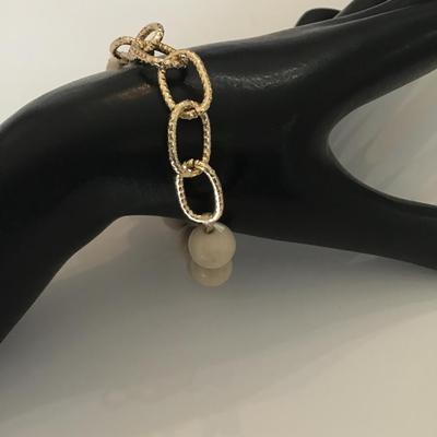 Creamy stone bead and gold tone stretch bracelet