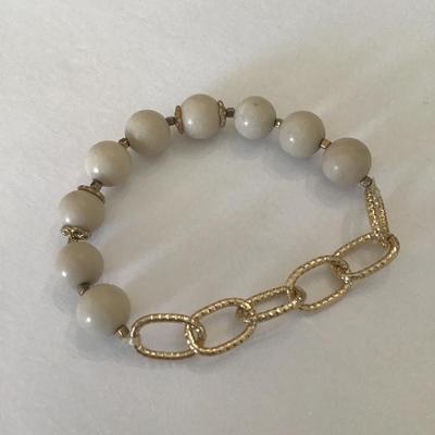 Creamy stone bead and gold tone stretch bracelet