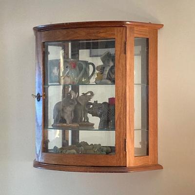 LOT 33: Wall Mount / Hanging Curio Cabinet with Glass Shelves & Doors with Collection of Collectible Elephant Decor