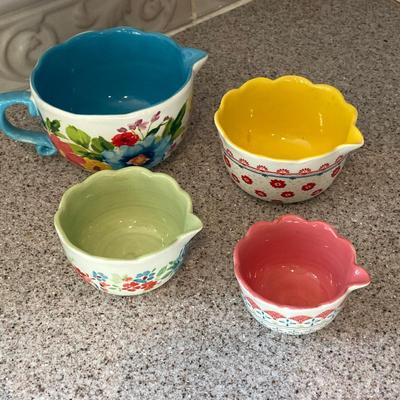 LOT 48: Kitchen Essentials - The Premier Woman Measuring Cups, Mom's Diner Napkin Holder / Butter Dish, Canisters, Towels and More