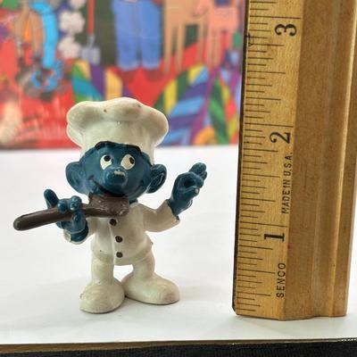 LOT 220: Master of the Universe Snout Spout (NIP), Smokey the Bear & Duck Tale Cardboard Puzzles and a Little Blue Friend Baker Smurf