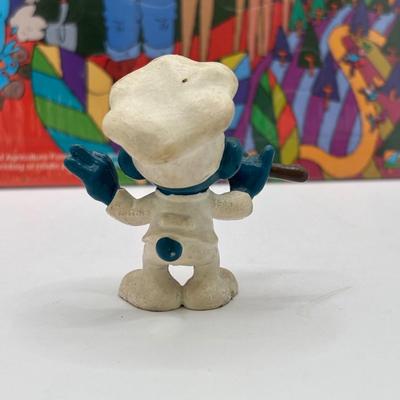 LOT 220: Master of the Universe Snout Spout (NIP), Smokey the Bear & Duck Tale Cardboard Puzzles and a Little Blue Friend Baker Smurf