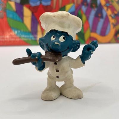 LOT 220: Master of the Universe Snout Spout (NIP), Smokey the Bear & Duck Tale Cardboard Puzzles and a Little Blue Friend Baker Smurf