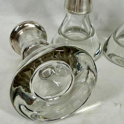 Sale Photo Thumbnail #84: Set of 4, excellent condition.  Elegant Kosta Boda candle holders. Features a silvered top and clear glass base. Made in Sweden. Approx. 4" tall.