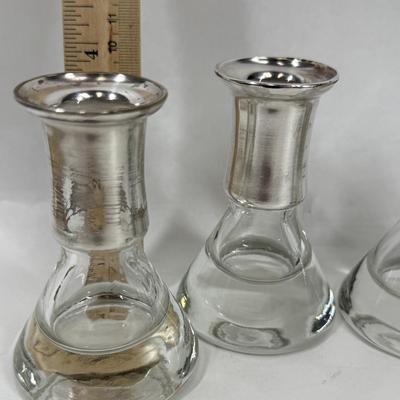 Sale Photo Thumbnail #81: Set of 4, excellent condition.  Elegant Kosta Boda candle holders. Features a silvered top and clear glass base. Made in Sweden. Approx. 4" tall.