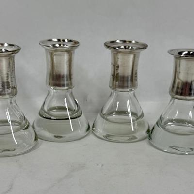 Sale Photo Thumbnail #78: Set of 4, excellent condition.  Elegant Kosta Boda candle holders. Features a silvered top and clear glass base. Made in Sweden. Approx. 4" tall.