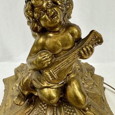 Sale Photo Thumbnail #333: Cast metal bronze-colored base with cherub playing a guitar. Chandelier-style crystal strands make up the shade for the three bulbs inside. Tested, works as expected.