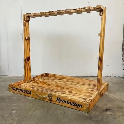Sale Photo Thumbnail #148: Free-standing wooden gun rack, designed for storing and displaying long guns such as rifles and shotguns. It has "WINCHESTER" & “Remington” logos on the front.
Made from pine. 
It is designed to be a portable, floor-standing storage solution, suitable