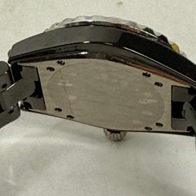 Sale Photo Thumbnail #366: In good used condition. Style is similar to the Chanel J12 Diver's watch, with rotating encrusted bezel.  Not working, may simply need a new battery.  Has a date window on the dial between the 4 & 5 position. Stored in a Chanel Sunglasses case.