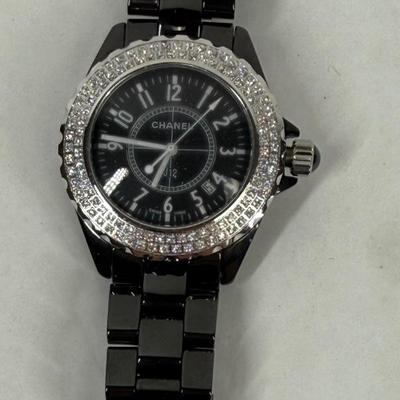 Sale Photo Thumbnail #371: In good used condition. Style is similar to the Chanel J12 Diver's watch, with rotating encrusted bezel.  Not working, may simply need a new battery.  Has a date window on the dial between the 4 & 5 position. Stored in a Chanel Sunglasses case.