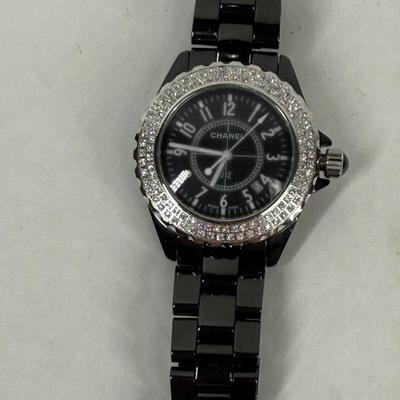 Sale Photo Thumbnail #372: In good used condition. Style is similar to the Chanel J12 Diver's watch, with rotating encrusted bezel.  Not working, may simply need a new battery.  Has a date window on the dial between the 4 & 5 position. Stored in a Chanel Sunglasses case.