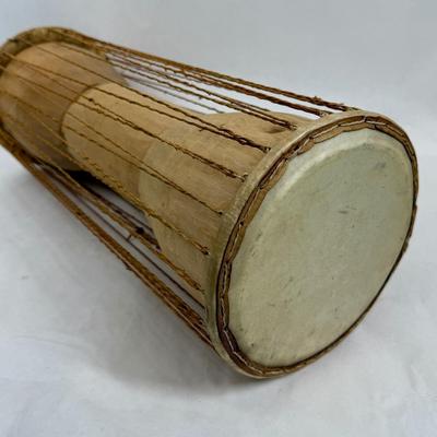 Sale Photo Thumbnail #394: 2 heads and leather tension cords. Player holds the drum under their arms and squeezes the cords to change the pitch, mimicking the. tones of human speech. In good used condition.