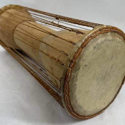 Sale Photo Thumbnail #395: 2 heads and leather tension cords. Player holds the drum under their arms and squeezes the cords to change the pitch, mimicking the. tones of human speech. In good used condition.