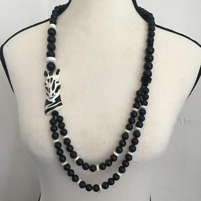 Beautiful, black and white faux beaded necklace with zebra pendant