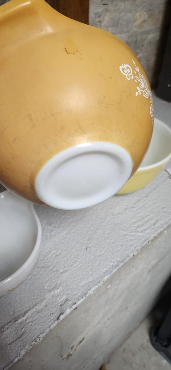 Sale Photo Thumbnail #12: Dishwasher damaged yellow 403 bowl. Note the damage. Butterfly gold Cinderella bowl set. Some damage on that 442 but it is a first generation.
