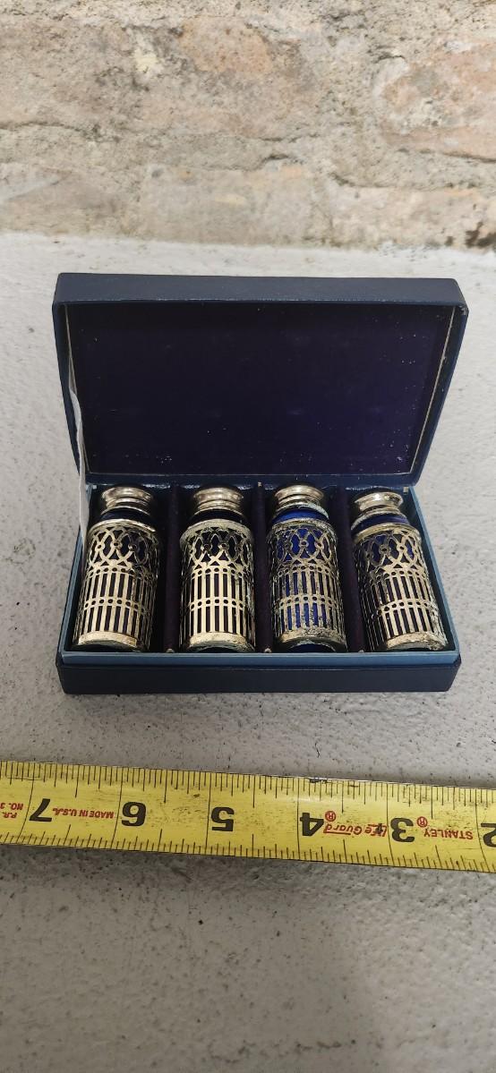 Sale Photo Thumbnail #54: Beautiful set of 4 cobalt glass shakers with silver casing and tops. Still have the original box