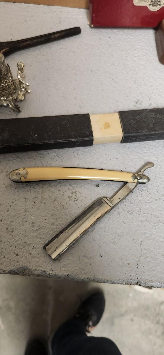 Sale Photo Thumbnail #153: Antique glasses, razors, curling iron, mirror....one of those razors have ivory on one side and what looks like tusk (?) on the other.