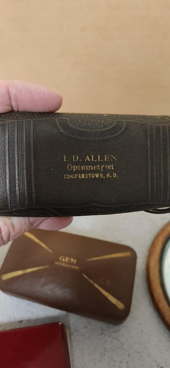 Sale Photo Thumbnail #159: Antique glasses, razors, curling iron, mirror....one of those razors have ivory on one side and what looks like tusk (?) on the other.