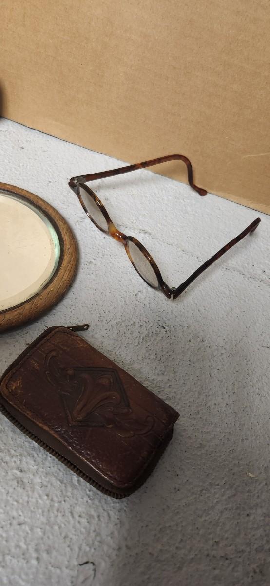 Sale Photo Thumbnail #160: Antique glasses, razors, curling iron, mirror....one of those razors have ivory on one side and what looks like tusk (?) on the other.