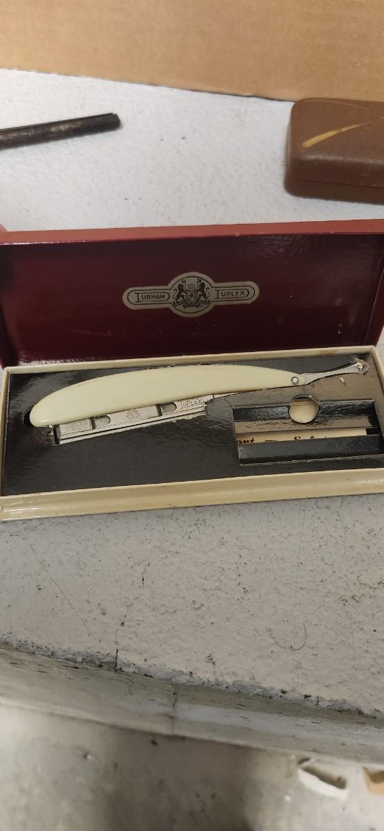 Sale Photo Thumbnail #156: Antique glasses, razors, curling iron, mirror....one of those razors have ivory on one side and what looks like tusk (?) on the other.