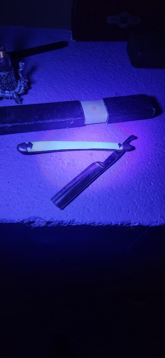 Sale Photo Thumbnail #154: Antique glasses, razors, curling iron, mirror....one of those razors have ivory on one side and what looks like tusk (?) on the other.