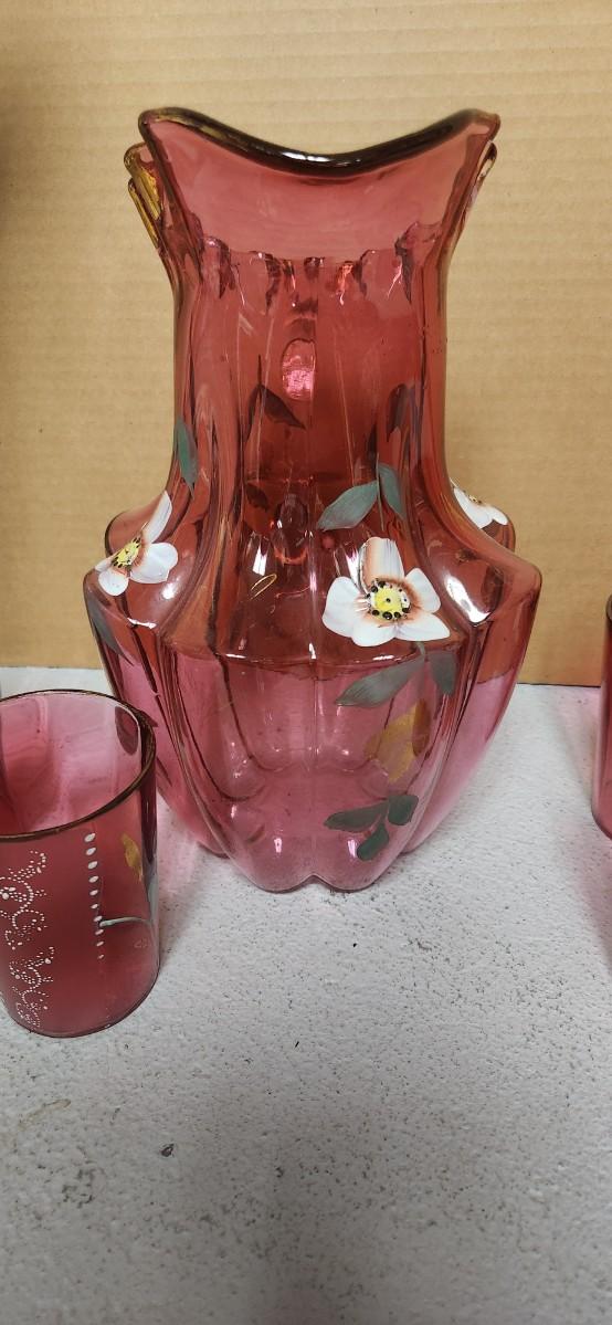 Sale Photo Thumbnail #196: Gorgeous Victorian cranberry pitcher and glasses with enamel paint. The pitcher is in excellent condition, the glasses are chippy