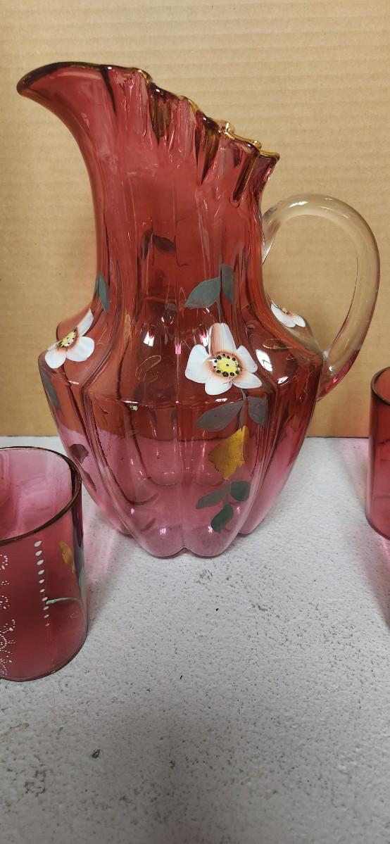 Sale Photo Thumbnail #197: Gorgeous Victorian cranberry pitcher and glasses with enamel paint. The pitcher is in excellent condition, the glasses are chippy